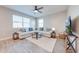 Bright and airy living room with a large white sectional sofa and a ceiling fan at 1860 Tohoqua Blvd, Kissimmee, FL 34744
