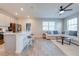 Open living space with a kitchen island, living room with modern furniture, and ample natural light at 1860 Tohoqua Blvd, Kissimmee, FL 34744