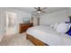 Bright main bedroom featuring wood dresser, ceiling fan, and ensuite bathroom with tiled shower at 1860 Tohoqua Blvd, Kissimmee, FL 34744