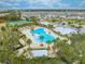A beautiful aerial view of the community pool area surrounded by palm trees and lush landscaping at 1860 Tohoqua Blvd, Kissimmee, FL 34744