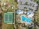 Aerial view of the community pool and tennis courts with ample parking and manicured landscaping at 1860 Tohoqua Blvd, Kissimmee, FL 34744