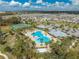 Aerial view of the community pool, tennis courts, and surrounding neighborhood in a Gathering-friendly community at 1860 Tohoqua Blvd, Kissimmee, FL 34744