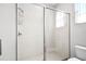 Tiled bathroom featuring a glass shower enclosure with white tiled walls and shower head at 240 Minniehaha Cir, Haines City, FL 33844