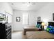 Bright bedroom featuring two twin beds, simple decor, and a ceiling fan at 240 Minniehaha Cir, Haines City, FL 33844