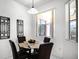Cozy breakfast nook with a glass-top table and seating for four, with a view from the large window at 240 Minniehaha Cir, Haines City, FL 33844