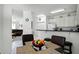 Breakfast nook with modern lighting, black bar, view of the kitchen, and fruit in a black bowl on the table at 240 Minniehaha Cir, Haines City, FL 33844