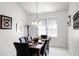 Dining room with chandelier, window with blinds and a black marble table with seating for six at 240 Minniehaha Cir, Haines City, FL 33844
