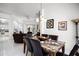 Open dining area with a marble top table that seats six, flowing into the adjacent living spaces at 240 Minniehaha Cir, Haines City, FL 33844