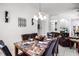 Open dining area with a marble top table that seats six, flowing into the adjacent living spaces at 240 Minniehaha Cir, Haines City, FL 33844