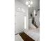 Bright foyer with tile flooring, staircase, and a view into other living spaces at 240 Minniehaha Cir, Haines City, FL 33844