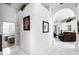 Hallway featuring tile floors, arched doorway and views into the living room and bedroom at 240 Minniehaha Cir, Haines City, FL 33844