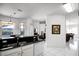Open-concept kitchen featuring black countertops, stainless steel appliances, and a view into the living room at 240 Minniehaha Cir, Haines City, FL 33844