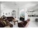 Bright living room featuring tile floors, ceiling fan, brown couches, marble-top table, and an open floor plan at 240 Minniehaha Cir, Haines City, FL 33844