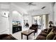 Cozy living room featuring tiled floors, an arched doorway, and sliding glass doors to the outdoor space at 240 Minniehaha Cir, Haines City, FL 33844
