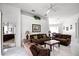Expansive living room with white tile floors, large couches, and view into the adjacent dining area and bedroom at 240 Minniehaha Cir, Haines City, FL 33844