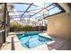 Backyard pool with jacuzzi and screened-in enclosure at 240 Minniehaha Cir, Haines City, FL 33844