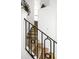 Carpeted staircase with decorative iron railing, leading to the upper level of the home at 240 Minniehaha Cir, Haines City, FL 33844