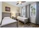 Bedroom featuring two twin beds, wooden floors, gray curtains, and modern decor at 2960 Caribbean Soul Dr, Kissimmee, FL 34747