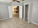 Bedroom showing closet and access to the kitchen in a home with tile floors at 304 Lake Daisy Loop, Winter Haven, FL 33884