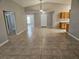 Spacious living room area with tile floors, neutral walls, vaulted ceilings, and views of the entry at 304 Lake Daisy Loop, Winter Haven, FL 33884