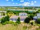 Aerial view of condominiums with ample parking, mature trees, and community landscaping at 3137 Sun Lake Ct # B, Kissimmee, FL 34747