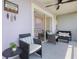 Cozy screened balcony with comfortable seating, outdoor furniture, ceiling fan, and sliding glass door to the indoors at 3137 Sun Lake Ct # B, Kissimmee, FL 34747