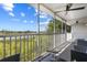 Screened in balcony view of a water and lush landscaping with a ceiling fan, and outdoor furniture at 3137 Sun Lake Ct # B, Kissimmee, FL 34747