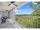 Screened in balcony view of a water and lush landscaping with a ceiling fan, and outdoor furniture at 3137 Sun Lake Ct # B, Kissimmee, FL 34747