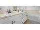 Bright bathroom with dual sinks, white cabinetry, vanity, and soaking tub at 3137 Sun Lake Ct # B, Kissimmee, FL 34747