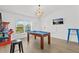 Game room features a pool table, wall mounted TV, arcade games, and stool seating at 3137 Sun Lake Ct # B, Kissimmee, FL 34747