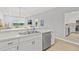 Well-lit kitchen equipped with stainless steel appliances, white cabinets, and a convenient breakfast bar area at 3137 Sun Lake Ct # B, Kissimmee, FL 34747
