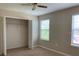 Bedroom with neutral carpet, bright natural light, an open closet and a ceiling fan at 3742 Maidencain St, Clermont, FL 34714