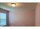 Bright bedroom with natural light, featuring pink walls and a window with horizontal blinds at 3742 Maidencain St, Clermont, FL 34714