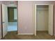 Bedroom with beige carpet, open closet with ample storage space, and easy access to other rooms at 3742 Maidencain St, Clermont, FL 34714