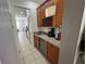 A bar area featuring wine storage, a mini-fridge, a sink, and storage on the way to the kitchen at 375 Orange Cosmos Blvd, Davenport, FL 33837