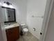 Compact half bath with a granite vanity and a clean, minimalist design at 375 Orange Cosmos Blvd, Davenport, FL 33837