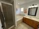 Bright bathroom featuring a separate shower and tub, alongside a modern vanity area at 375 Orange Cosmos Blvd, Davenport, FL 33837