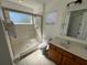 Bright bathroom featuring a glass-enclosed shower, and a spacious vanity with ample lighting at 375 Orange Cosmos Blvd, Davenport, FL 33837
