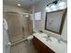 Clean bathroom with a glass-enclosed shower and a spacious vanity with ample lighting at 375 Orange Cosmos Blvd, Davenport, FL 33837