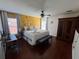 Bright primary bedroom with a swan towel display, wood floors, and a colorful decorative wall at 375 Orange Cosmos Blvd, Davenport, FL 33837