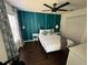 Bright bedroom with a queen-sized bed, modern ceiling fan, accent wall, and bright window views at 375 Orange Cosmos Blvd, Davenport, FL 33837
