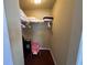 Walk-in closet featuring built-in shelving, carpeted floors, and hanging storage at 375 Orange Cosmos Blvd, Davenport, FL 33837