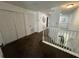 Spacious upstairs hallway with plush carpeting, closet storage, and a view of the stairs at 375 Orange Cosmos Blvd, Davenport, FL 33837