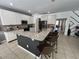 A kitchen featuring gray lower cabinets, white upper cabinets, granite counters and stainless steel appliances at 375 Orange Cosmos Blvd, Davenport, FL 33837