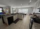 Well-lit kitchen with granite countertops, stainless steel appliances, and adjacent dining area at 375 Orange Cosmos Blvd, Davenport, FL 33837