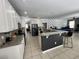 Open-concept kitchen featuring granite counters, a breakfast bar, and seamless flow into living area at 375 Orange Cosmos Blvd, Davenport, FL 33837