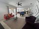 Open-concept living space with pool table, bright sofa, and access to an outdoor patio with a pool at 375 Orange Cosmos Blvd, Davenport, FL 33837