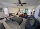 Spacious living room with tile flooring, a sectional sofa, stairs, and lots of natural light at 375 Orange Cosmos Blvd, Davenport, FL 33837