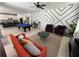 Spacious living room featuring a pool table, modern seating, and an open flow into the kitchen at 375 Orange Cosmos Blvd, Davenport, FL 33837