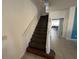 Carpeted staircase leading to the upper level with views to the open floor plan at 375 Orange Cosmos Blvd, Davenport, FL 33837